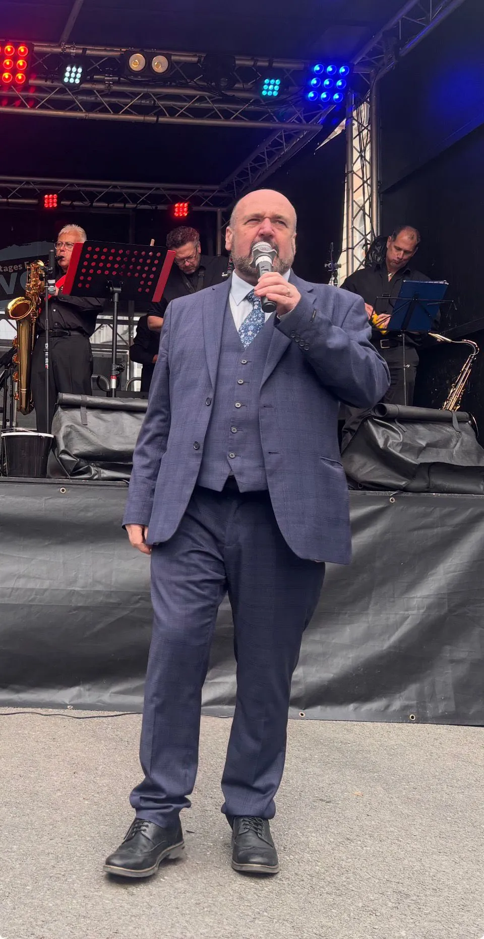 A host introducing acts on stage