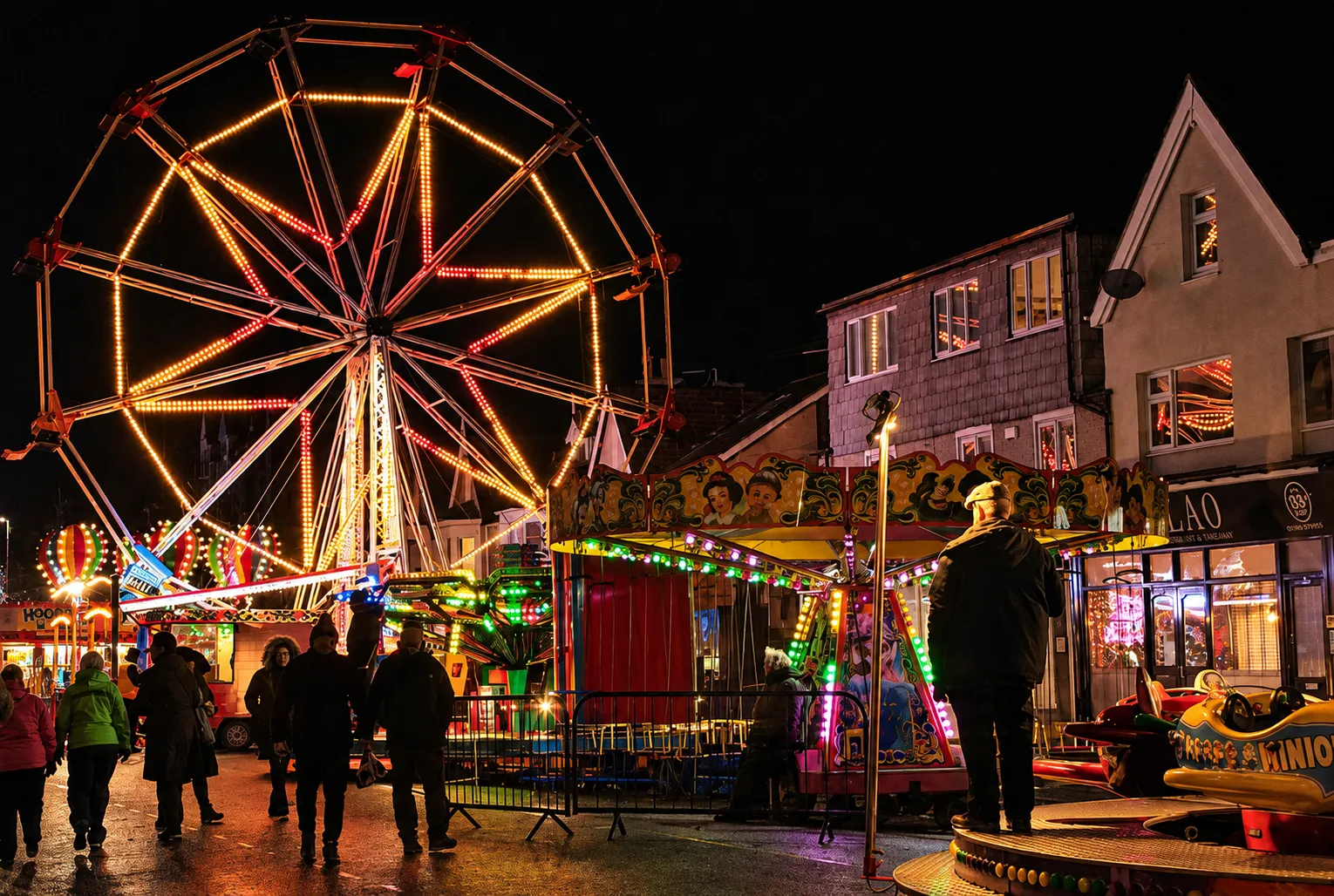 A brightly lit ferris wheel, warm colours in the evening